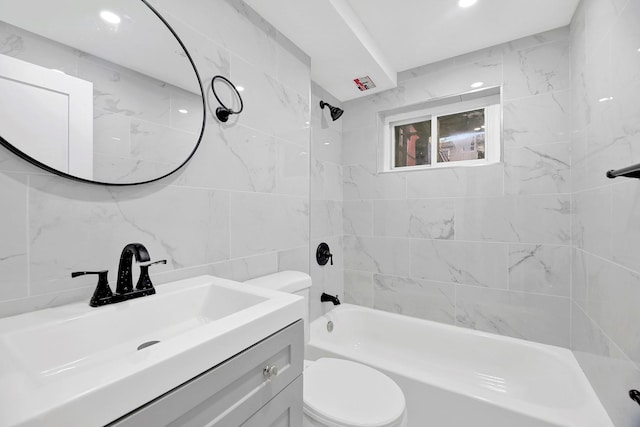 full bathroom featuring backsplash, vanity, tiled shower / bath combo, tile walls, and toilet