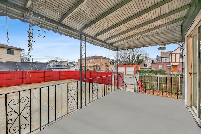 view of patio / terrace featuring a garage and an outbuilding