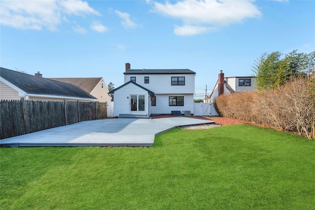 rear view of house featuring a yard and a wooden deck