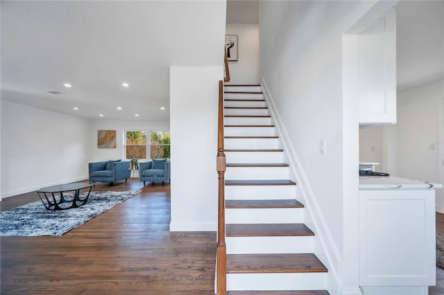 stairs featuring wood-type flooring