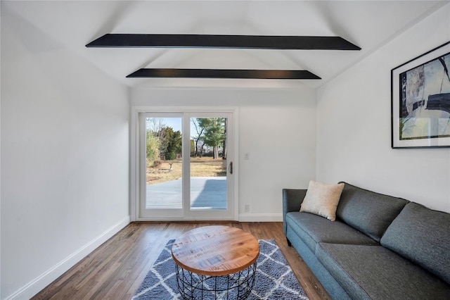 living room featuring lofted ceiling with beams and wood-type flooring