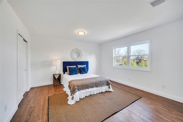 bedroom with hardwood / wood-style floors