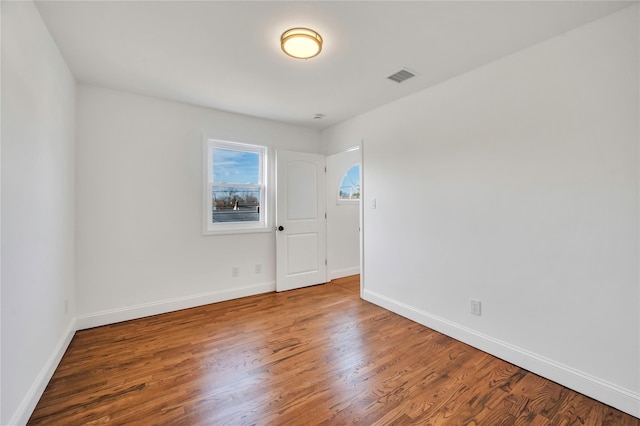 spare room with hardwood / wood-style flooring