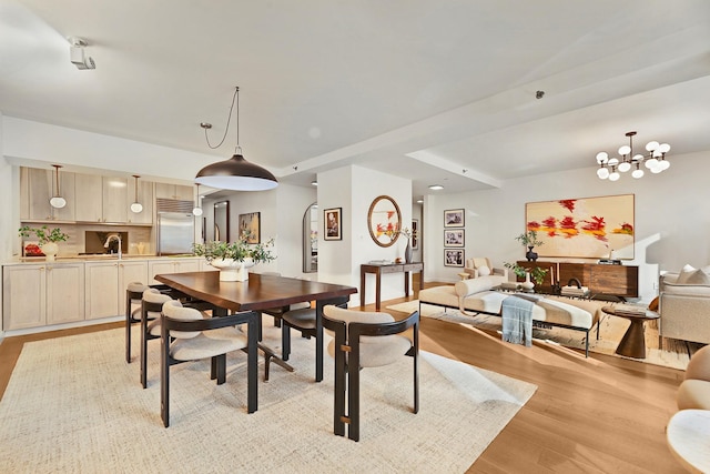 dining area with a chandelier and light hardwood / wood-style flooring