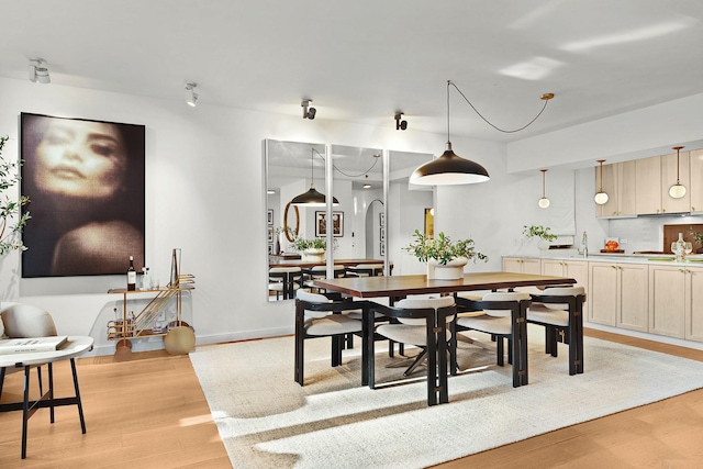 dining room with light wood-type flooring and sink