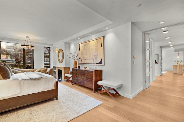 bedroom featuring light hardwood / wood-style floors and an inviting chandelier