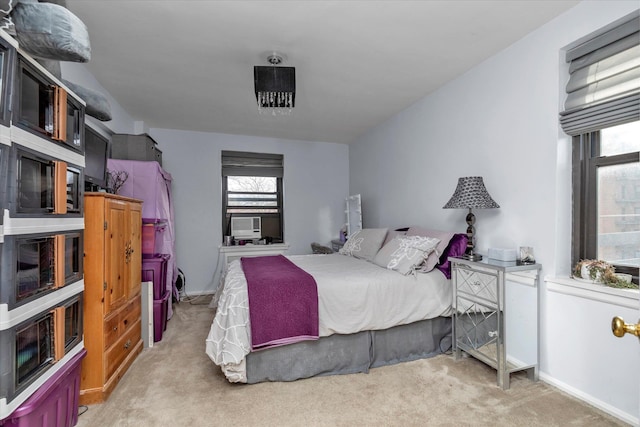 bedroom featuring light carpet and cooling unit