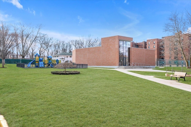 view of home's community with a playground and a yard