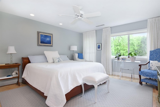 bedroom with light hardwood / wood-style flooring and ceiling fan