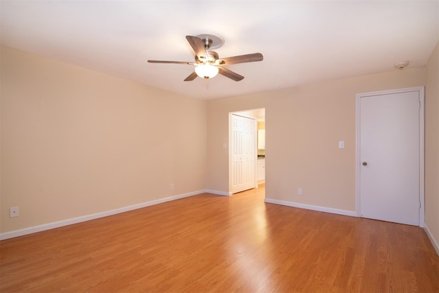 empty room featuring ceiling fan and light wood-type flooring