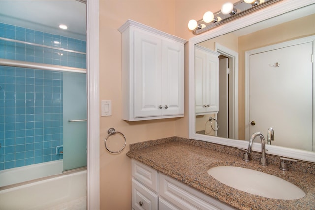 bathroom featuring vanity and combined bath / shower with glass door