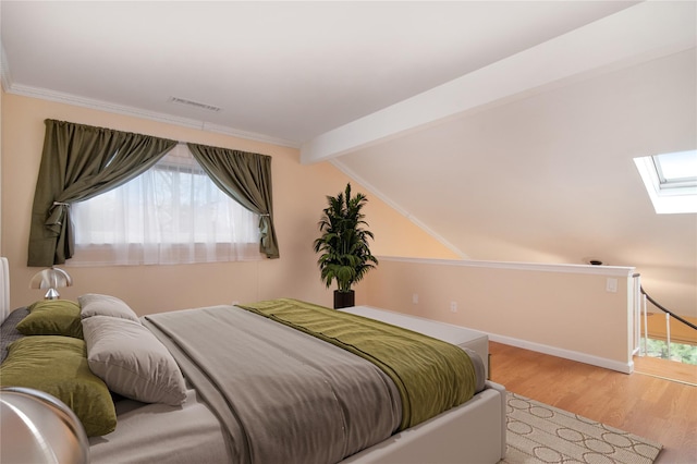 bedroom with light hardwood / wood-style flooring and lofted ceiling with skylight