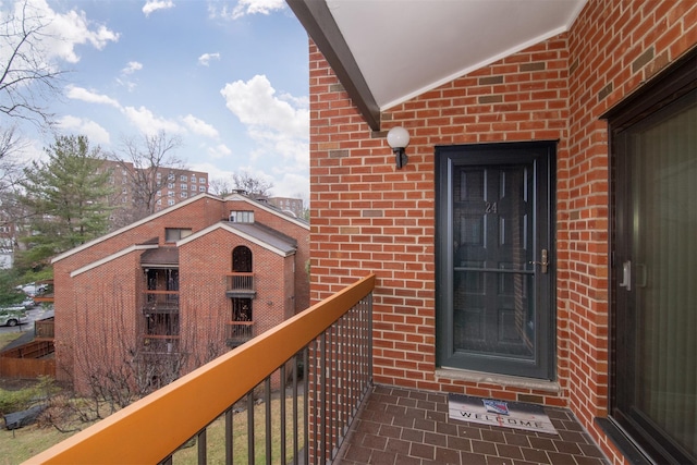 view of exterior entry with a balcony