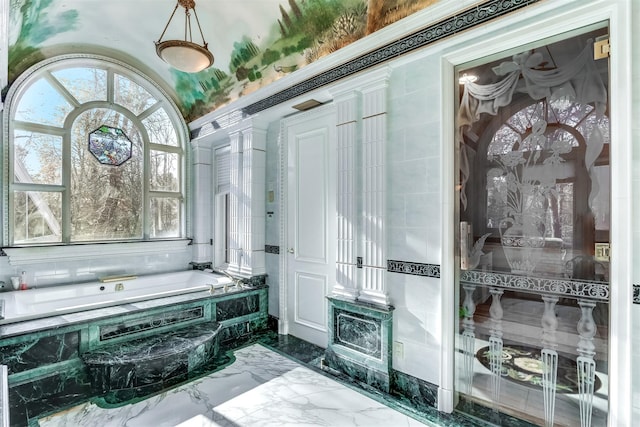 bathroom featuring tiled tub