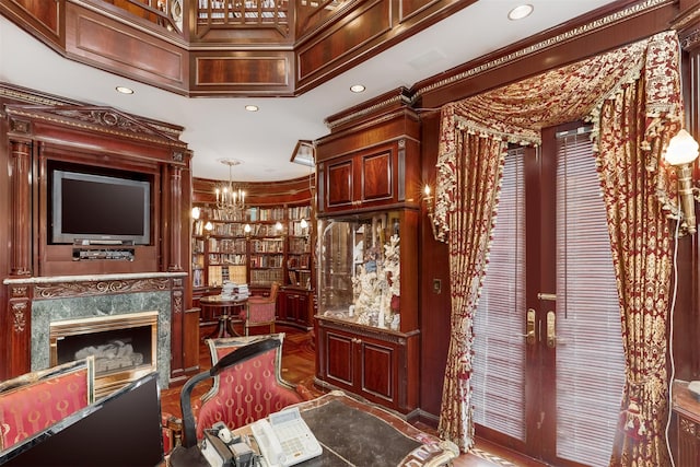 bar with crown molding, a high end fireplace, and a chandelier