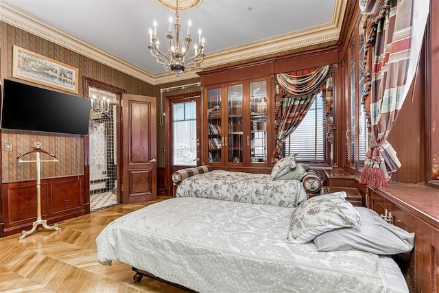 bedroom featuring light parquet floors, a chandelier, and ornamental molding