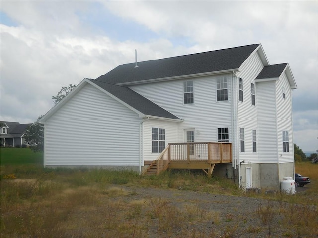 back of property featuring a wooden deck