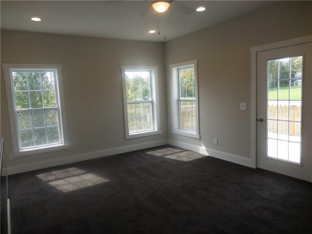 carpeted spare room with ceiling fan