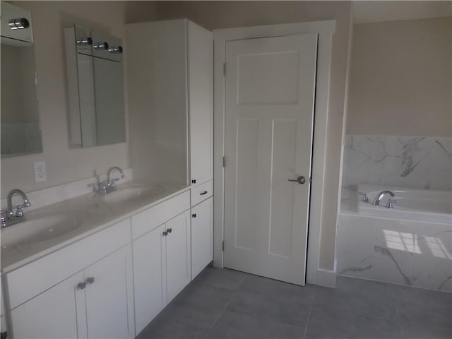 bathroom featuring a tub to relax in, tile patterned flooring, and vanity