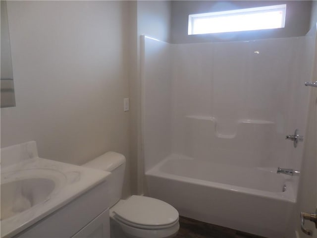 full bathroom featuring vanity, washtub / shower combination, and toilet