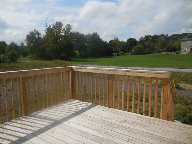 wooden deck featuring a yard