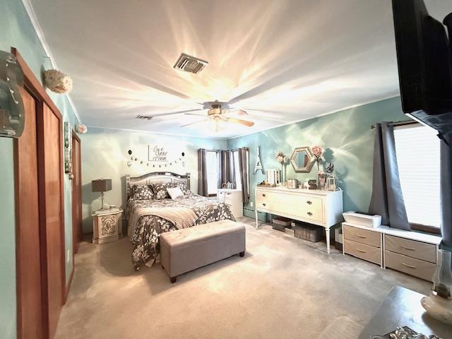 carpeted bedroom with ceiling fan