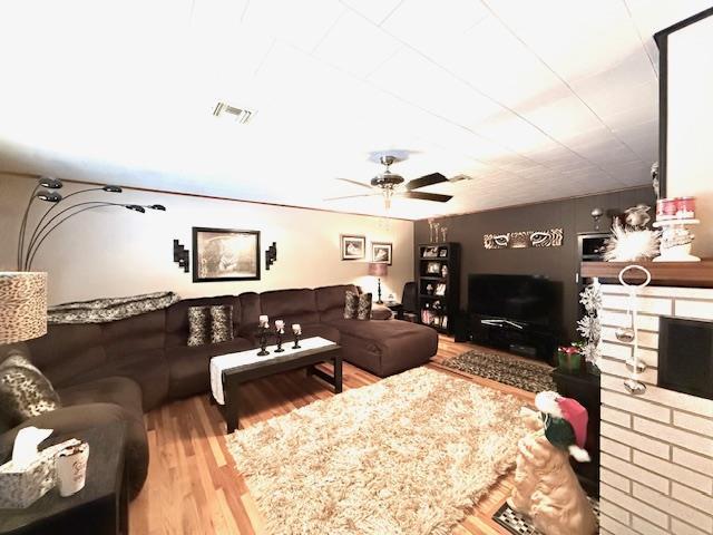 living room featuring ceiling fan and wood-type flooring