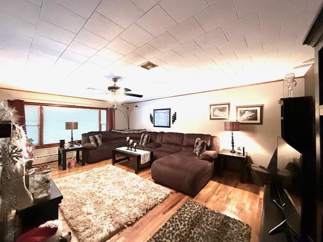 living room with ceiling fan and wood-type flooring