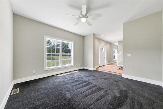 unfurnished living room with carpet flooring and ceiling fan