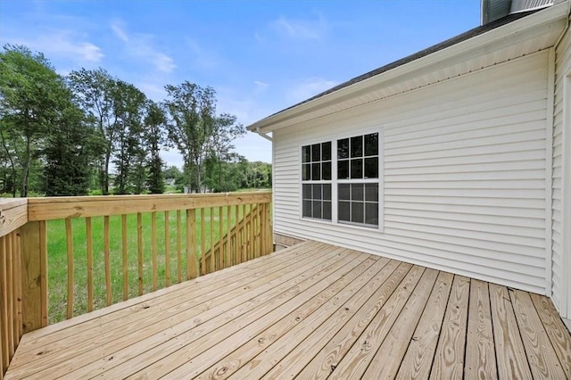 wooden terrace with a yard