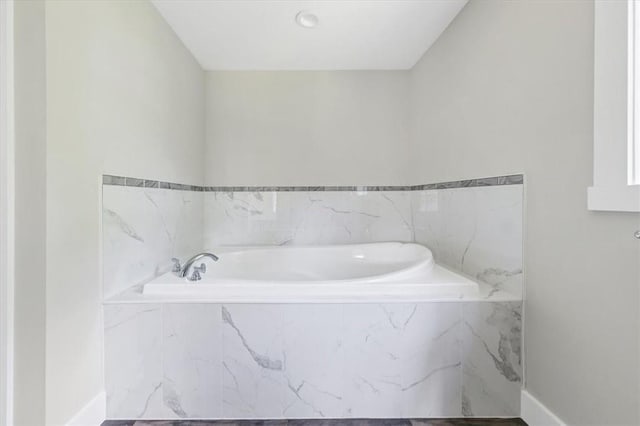 bathroom featuring tiled bath