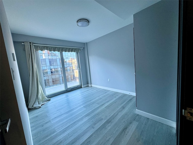 empty room with light hardwood / wood-style flooring