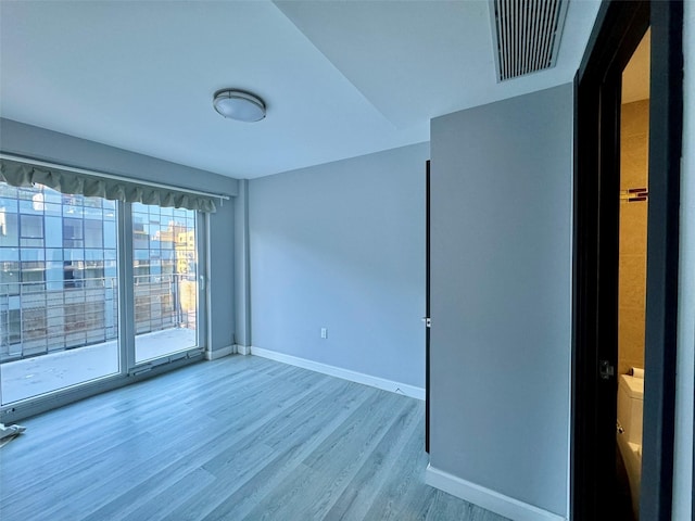 spare room featuring light hardwood / wood-style floors