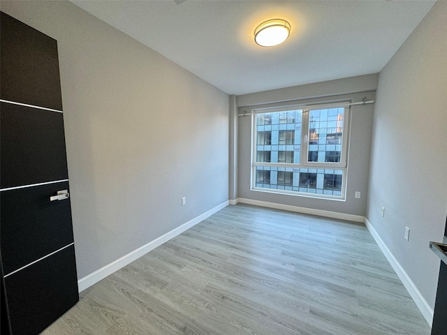 unfurnished room featuring light hardwood / wood-style floors