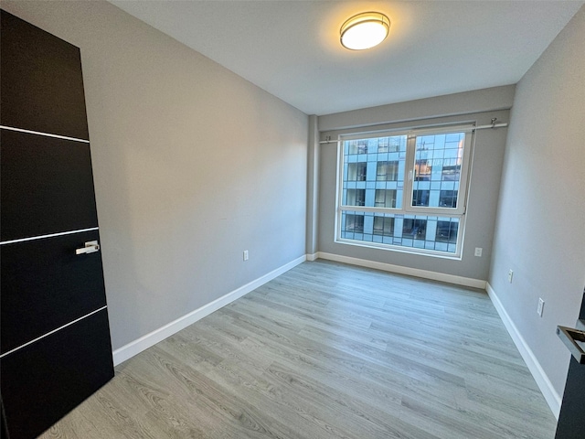 spare room featuring light hardwood / wood-style floors