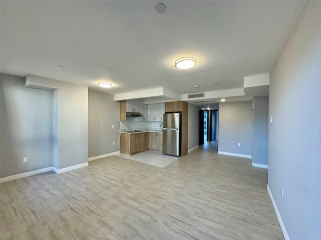 unfurnished living room with light hardwood / wood-style flooring