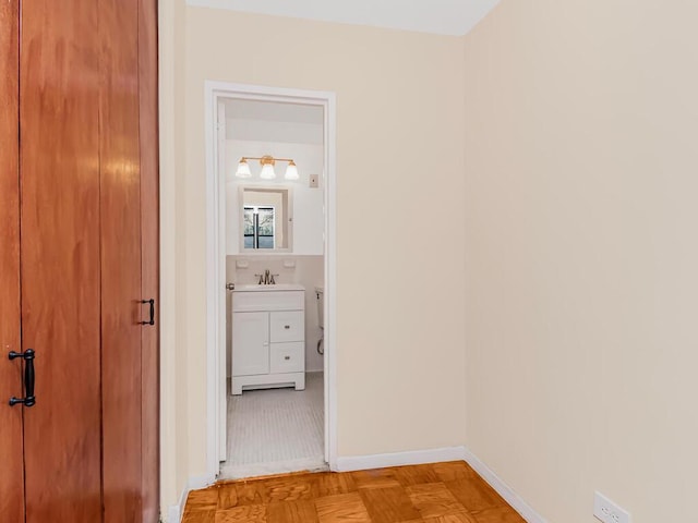 hall featuring light parquet flooring and sink