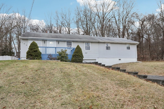 rear view of house featuring a yard