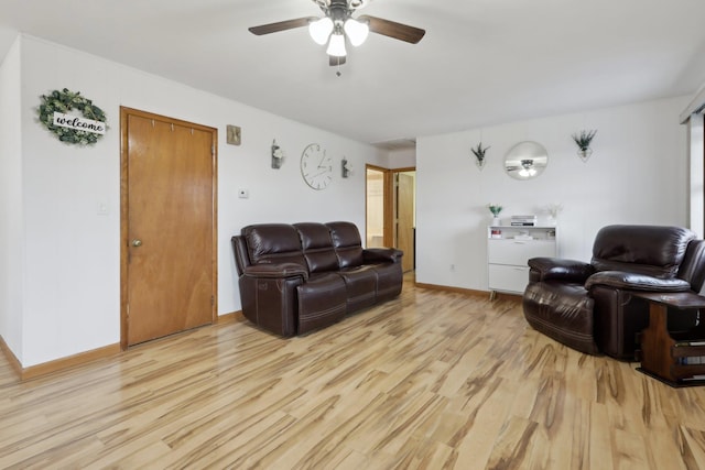 living room featuring ceiling fan and light wood-type flooring