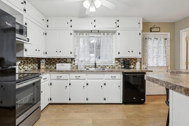 kitchen featuring white cabinets, decorative backsplash, and black appliances