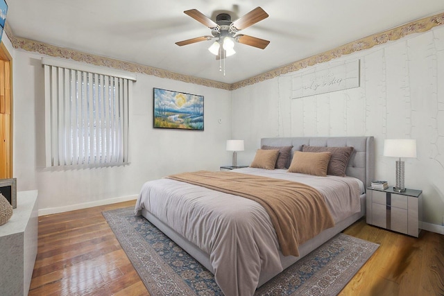 bedroom with ceiling fan and dark hardwood / wood-style flooring