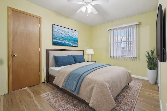 bedroom with light hardwood / wood-style floors and ceiling fan