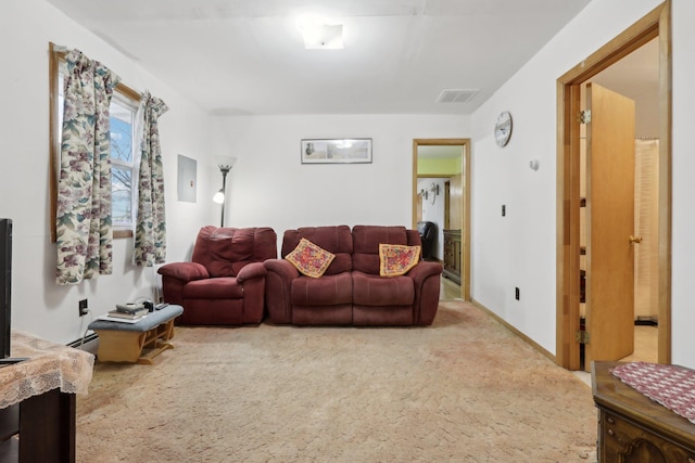 living room featuring baseboard heating and carpet floors