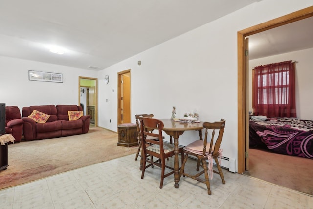 carpeted dining space with a baseboard radiator