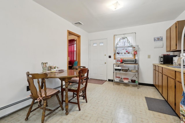 dining space with a baseboard radiator