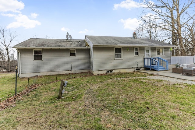 back of house featuring a lawn and a patio