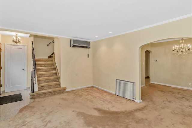 unfurnished living room with radiator heating unit, a chandelier, ornamental molding, stairway, and a wall mounted AC