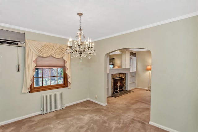 unfurnished dining area with radiator heating unit, baseboards, carpet floors, arched walkways, and a chandelier
