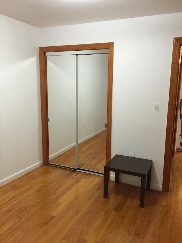 bedroom featuring a closet and light hardwood / wood-style floors