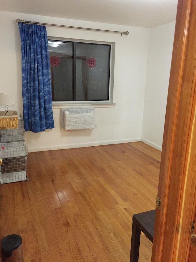 spare room with hardwood / wood-style floors